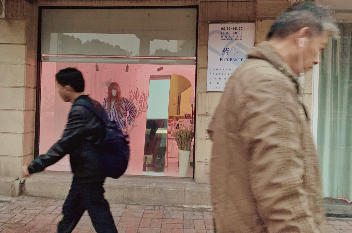 A man walking down the street with a backpack.